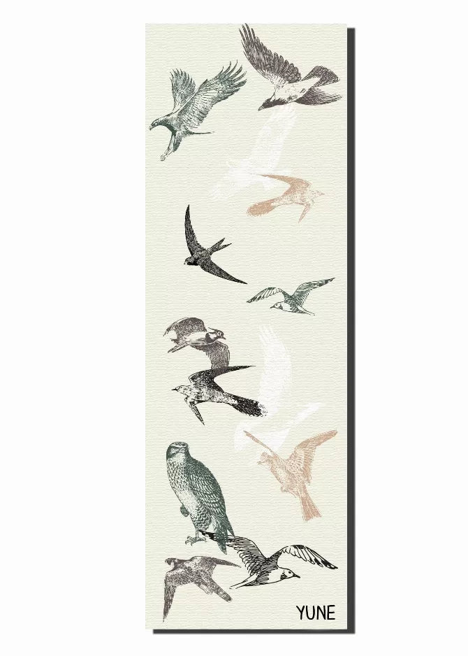 Cream yoga mat with vertically arranged birds and YUNE logo at bottom