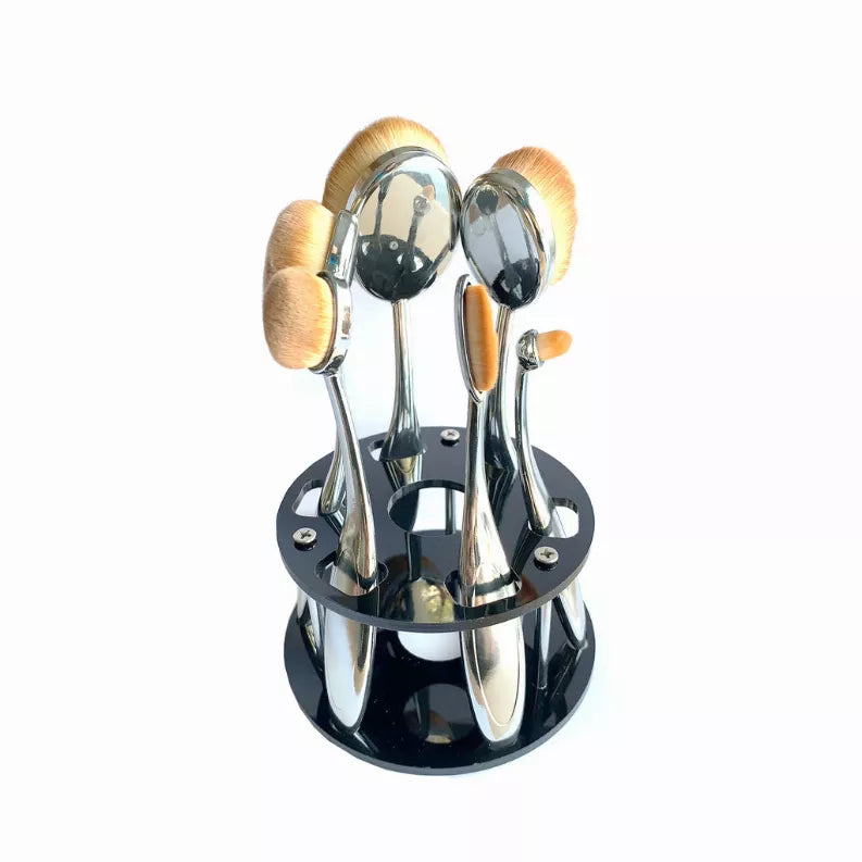 Oval makeup brushes in a shiny chrome caddy organizer with round base