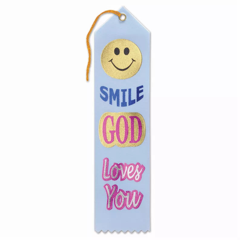 Blue award ribbon with smiley face text: Smile, God Loves You, and orange hanging cord
