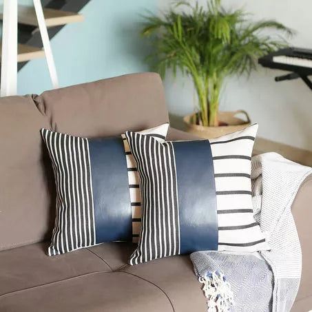 Set of 2 striped faux leather pillow covers with black, white, and dark blue panels