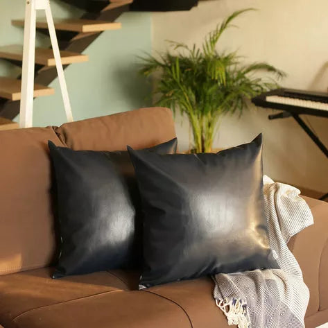 Black faux leather throw pillows, square with subtle sheen and smooth texture