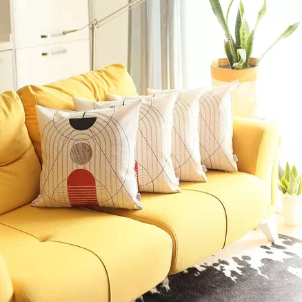 White printed throw pillow cover with concentric arch lines and red-and-gray stacked figures
