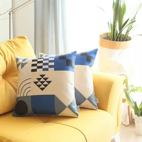 Geometric printed throw pillow covers on yellow sofa, cream and blue abstract pattern