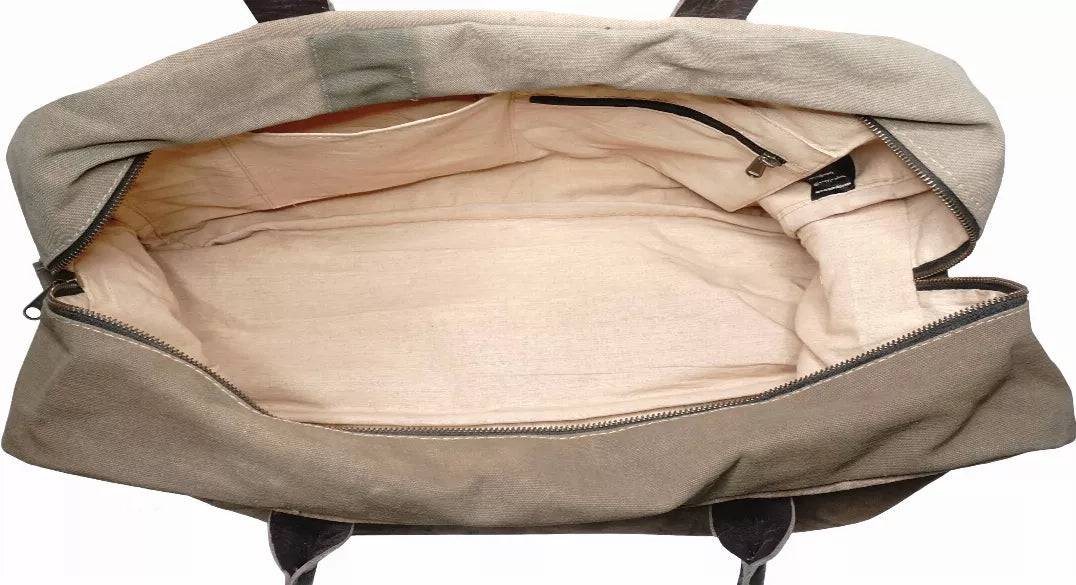 Khaki canvas travel bag open at top, showing light inner lining and zipper opening