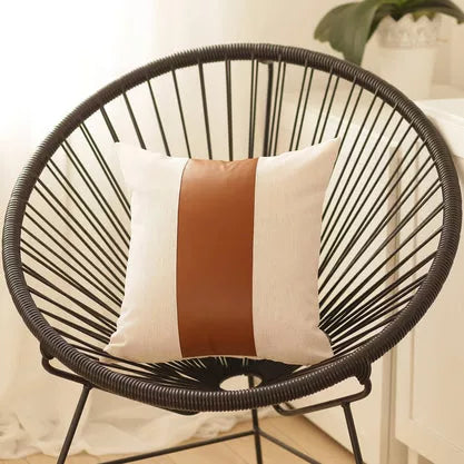 Square throw pillow cover with centered brown faux-leather vertical stripe on off-white