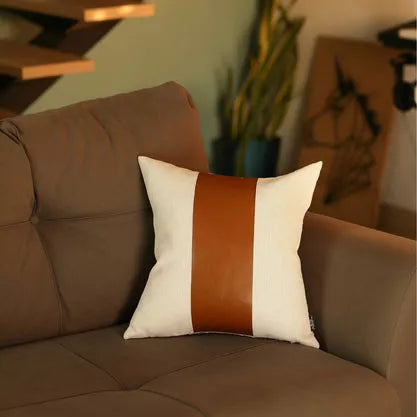 Square throw pillow cover with centered brown faux-leather vertical stripe on off-white fabric