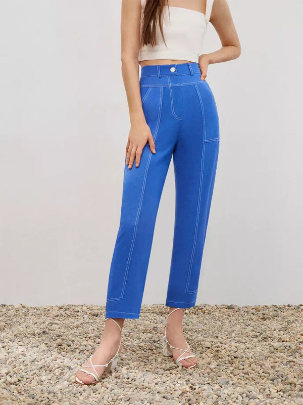 Blue linen carrot pants with contrast stitching, front pockets, and button closure