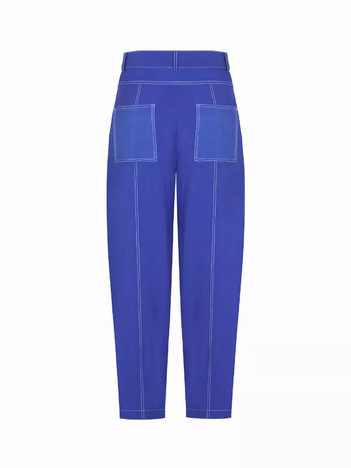 Blue linen carrot pants, back view with patch pockets and contrast seam lines