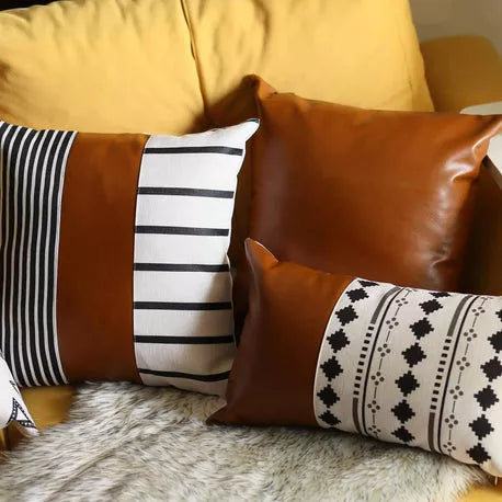 Brown faux leather pillow with white-and-black striped and diamond pattern throw pillows