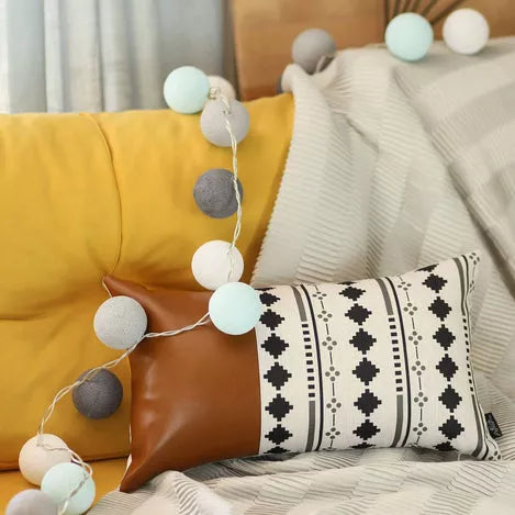 Brown faux leather throw pillow, rectangular with smooth finish beside boho accent pillow