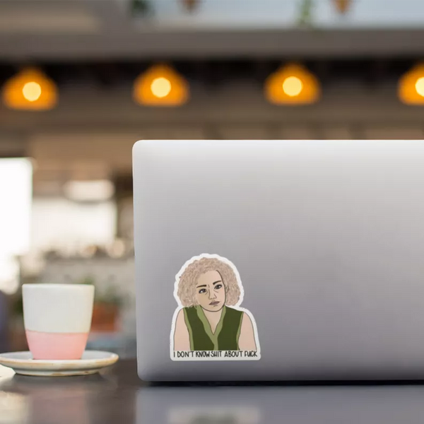 Small woman portrait sticker on laptop screen, curly hair and green top
