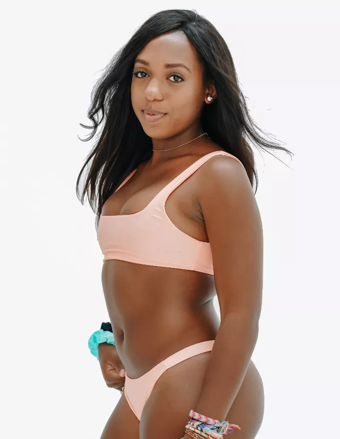 Peach scoop-neck bikini top with thin straps, side view
