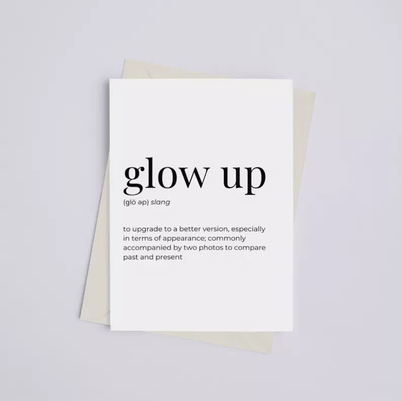 White card with centered “glow up” lettering; beige backing sheet behind.