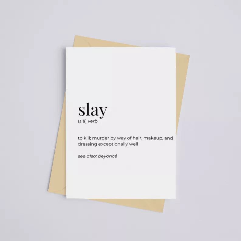 Greeting card with 'slay' typography on white front over kraft envelope