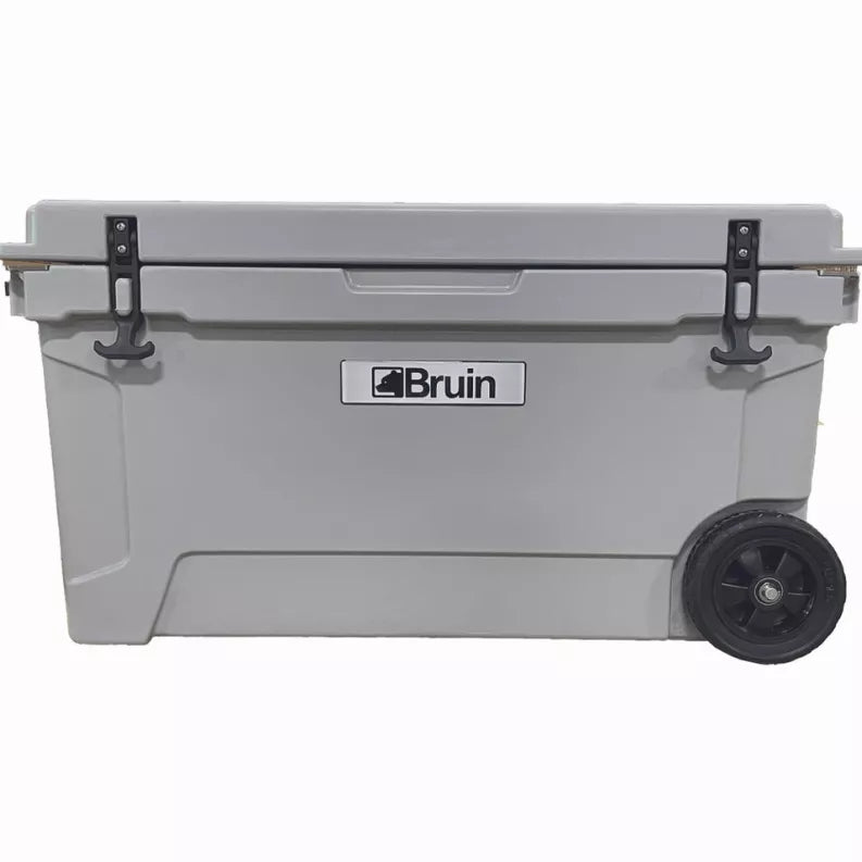 Gray roto-molded cooler with Bruin logo, side latches and front wheel.