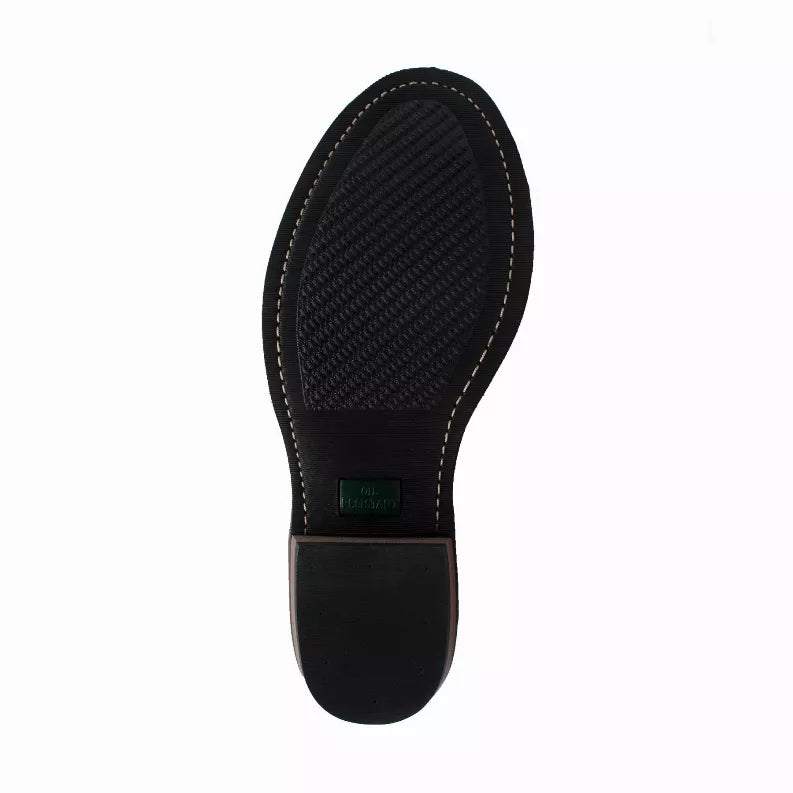 Boot outsole view: textured dark rubber tread with stitched edge and dark heel pad