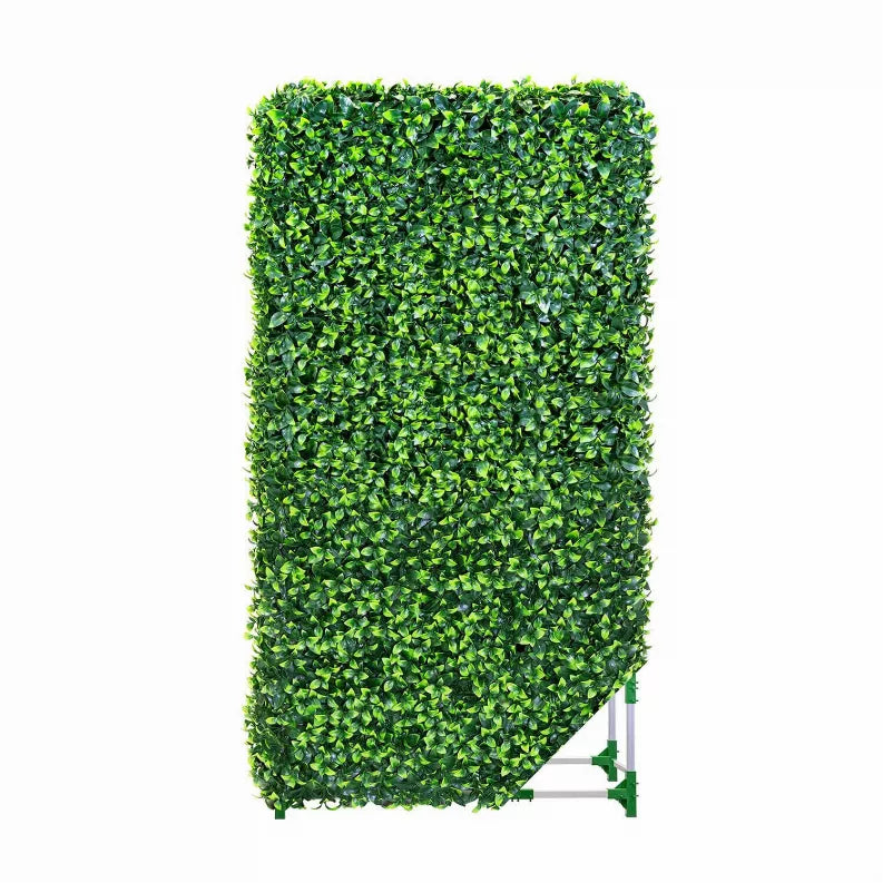 Freestanding artificial hedge panel with dense green foliage on white aluminum base frame.