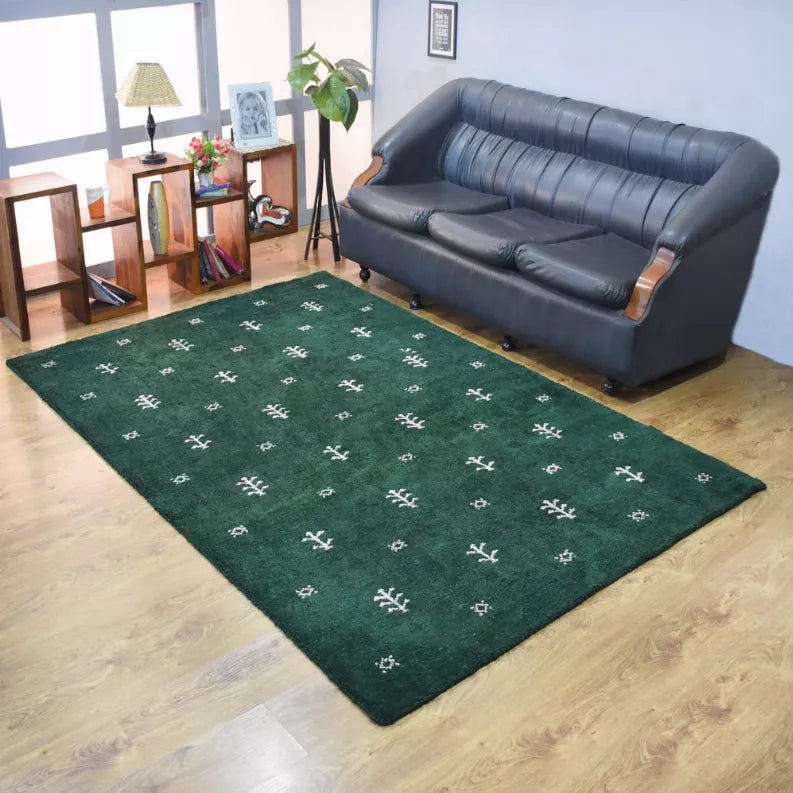 Green area rug with white geometric motif pattern, hand-knotted textured pile