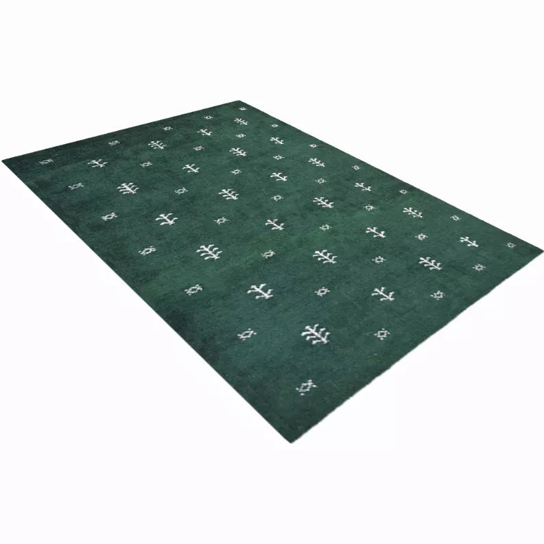 Dark green area rug with white geometric cross motifs on a flat background
