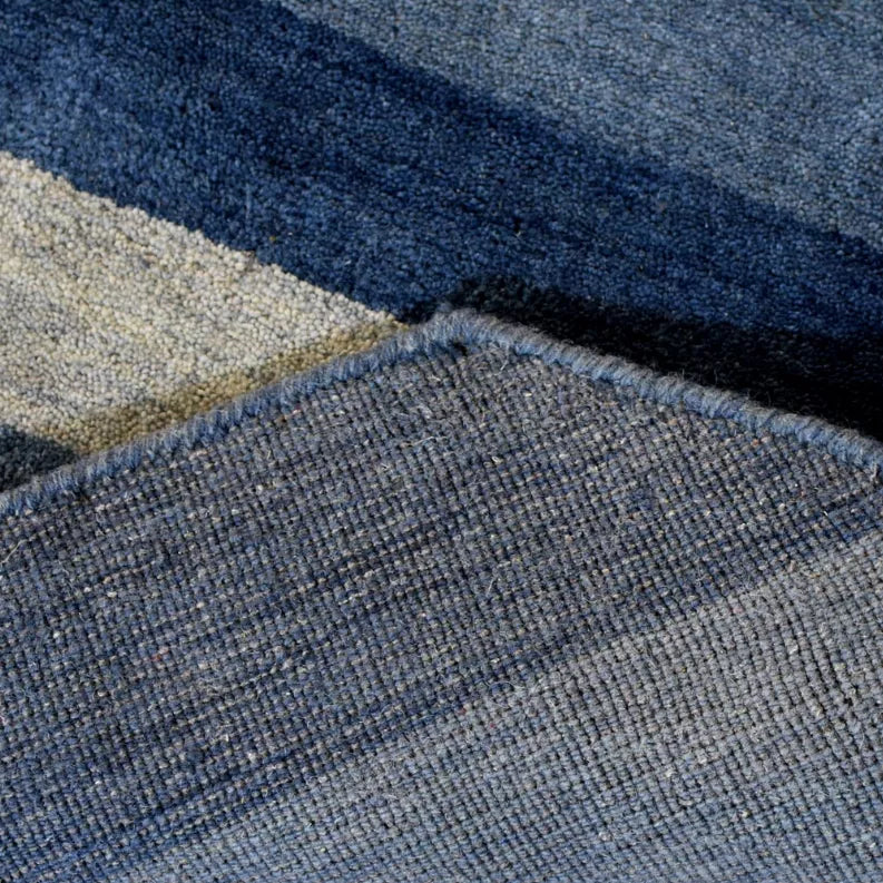 Octagon area rug corner close-up showing stitched texture and layered pile