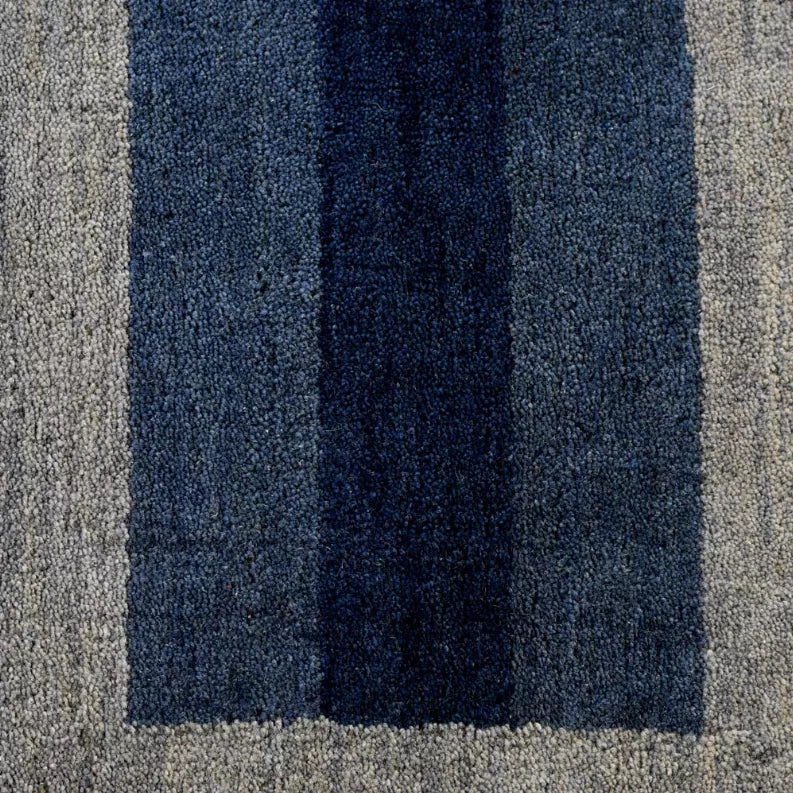 Close-up of blue and gray vertical striped octagon area rug pattern texture