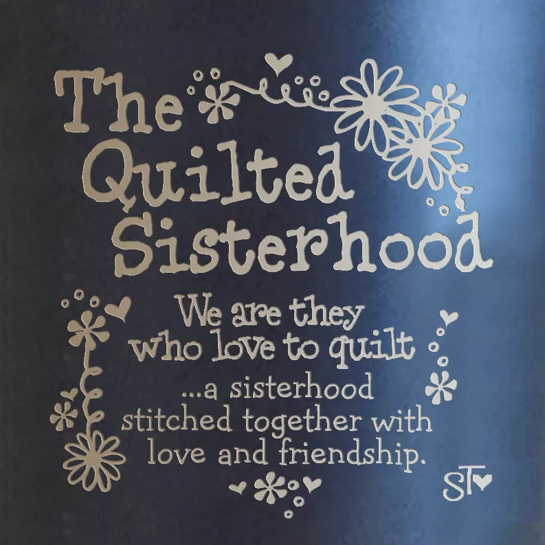 Black tumbler with "The Quilted Sisterhood" blue and gold floral graphic