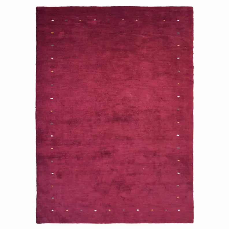 Maroon rectangle area rug with tiny scattered specks and low, textured pile