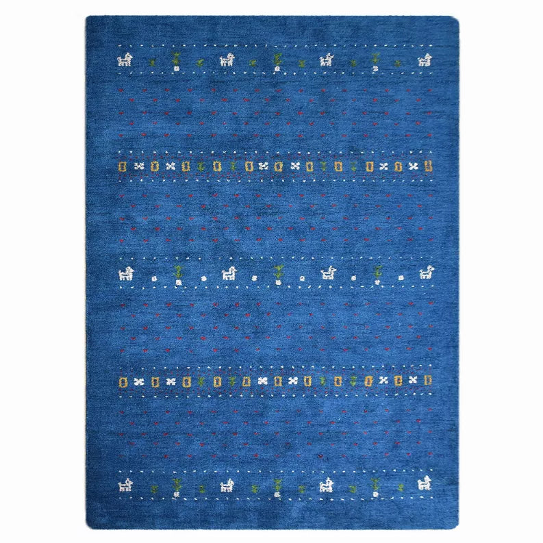 Blue area rug with scattered small multicolor geometric motifs and central band