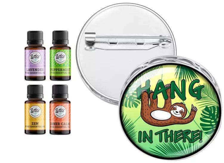 Round chrome pin brooch diffuser with sloth “Hang In There” graphic, with scent bottles