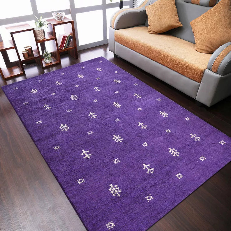 Purple geometric area rug with small white motifs on a living room floor