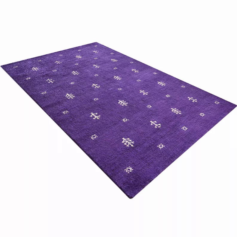Purple area rug on a white background, diagonal view with small white motifs