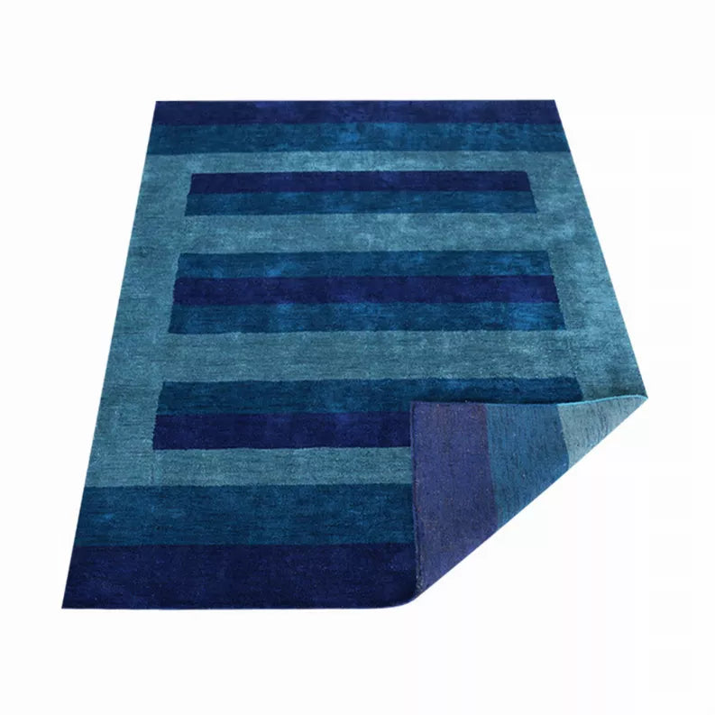 Hand-knotted style area rug with teal and navy horizontal stripe blocks