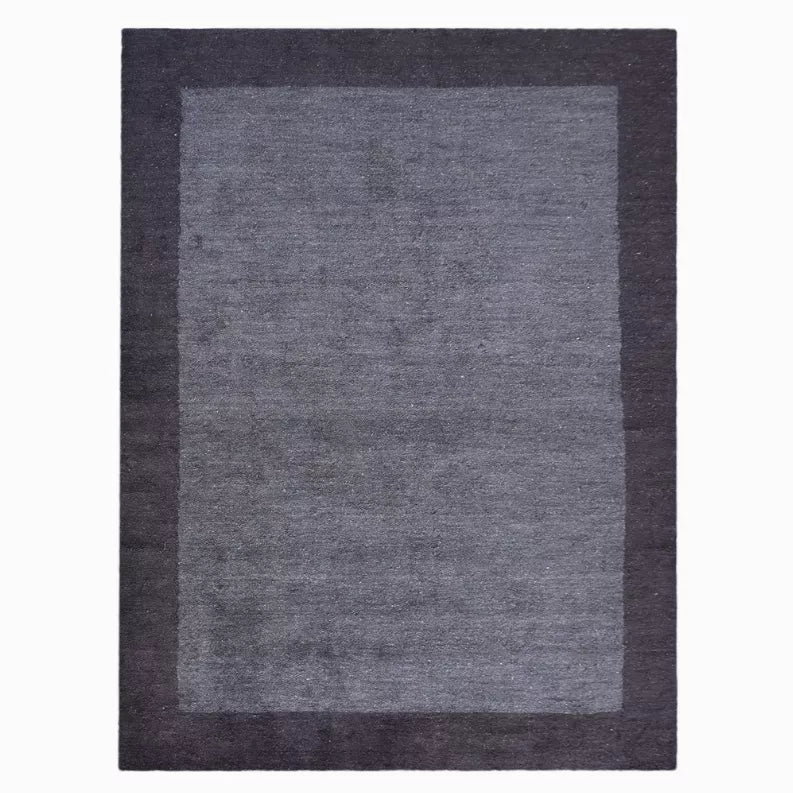 Dark charcoal area rug with medium gray square center and darker border, top view
