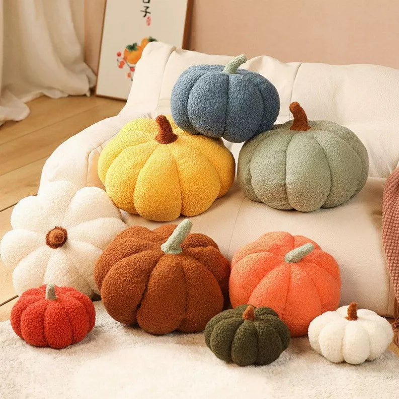 Mixed-color boucle pumpkin pillow set arranged on a couch