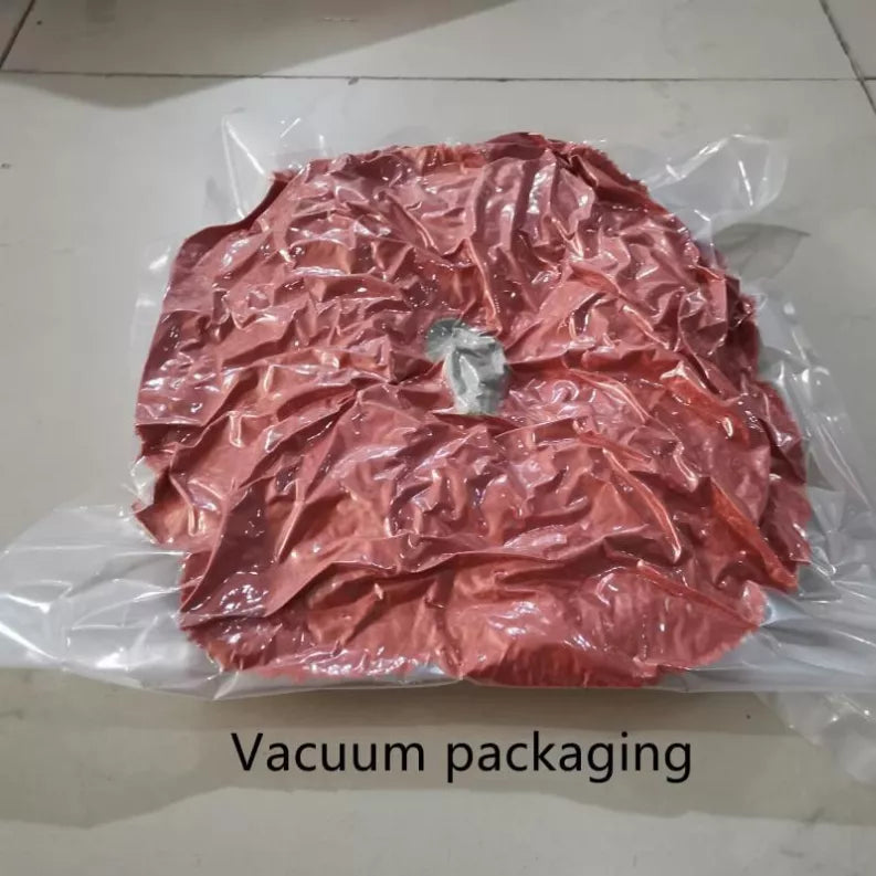 Vacuum-sealed pumpkin pillow in clear plastic bag, reddish-brown color