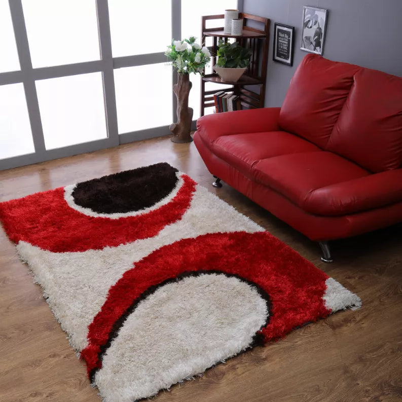 Shag area rug with red, black, and cream geometric arch pattern