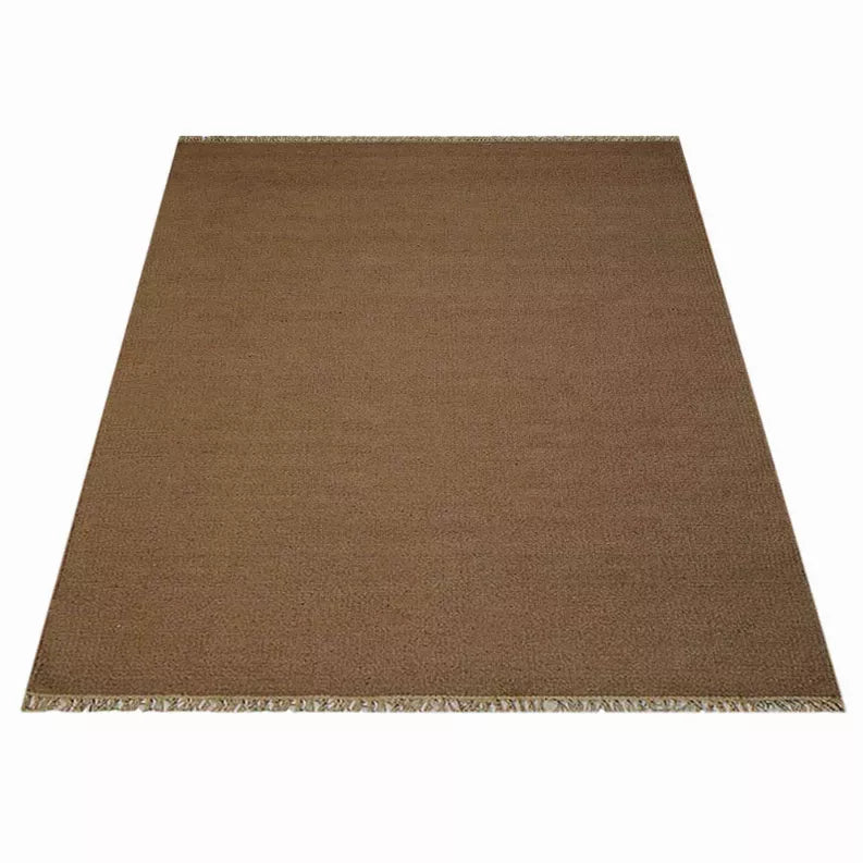 Rectangular solid brown area rug with cream fringe trim on white background