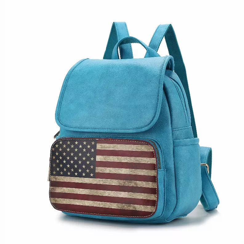Turquoise mini backpack with American flag front panel, top flap, and adjustable straps.