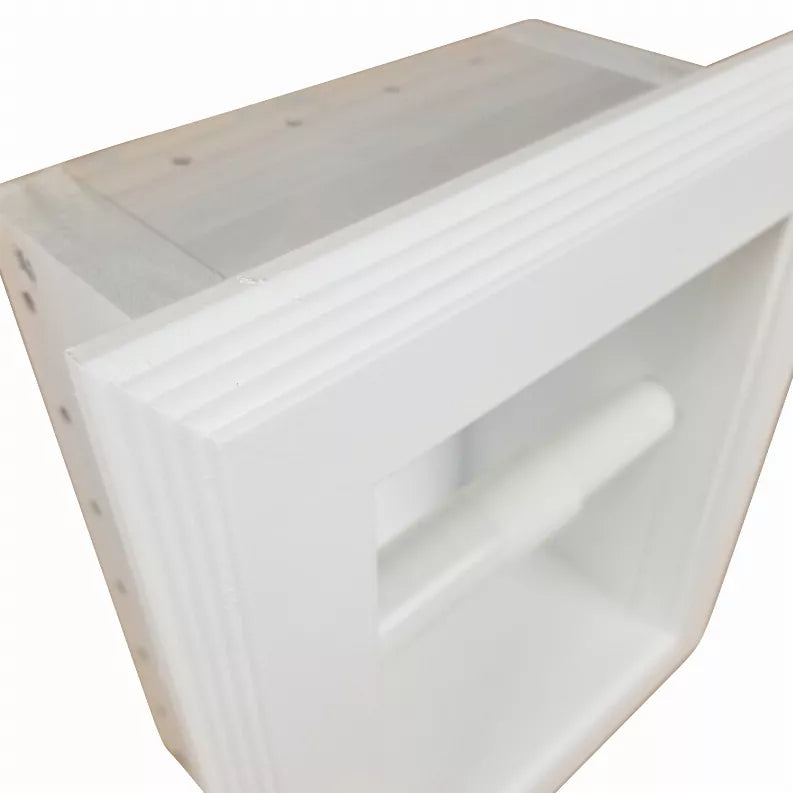 Recessed toilet paper holder close-up showing white front panel and roll compartment