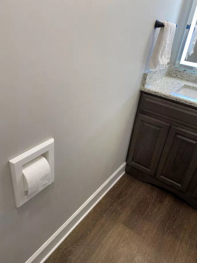 Wall-mounted recessed toilet paper holder with a roll installed