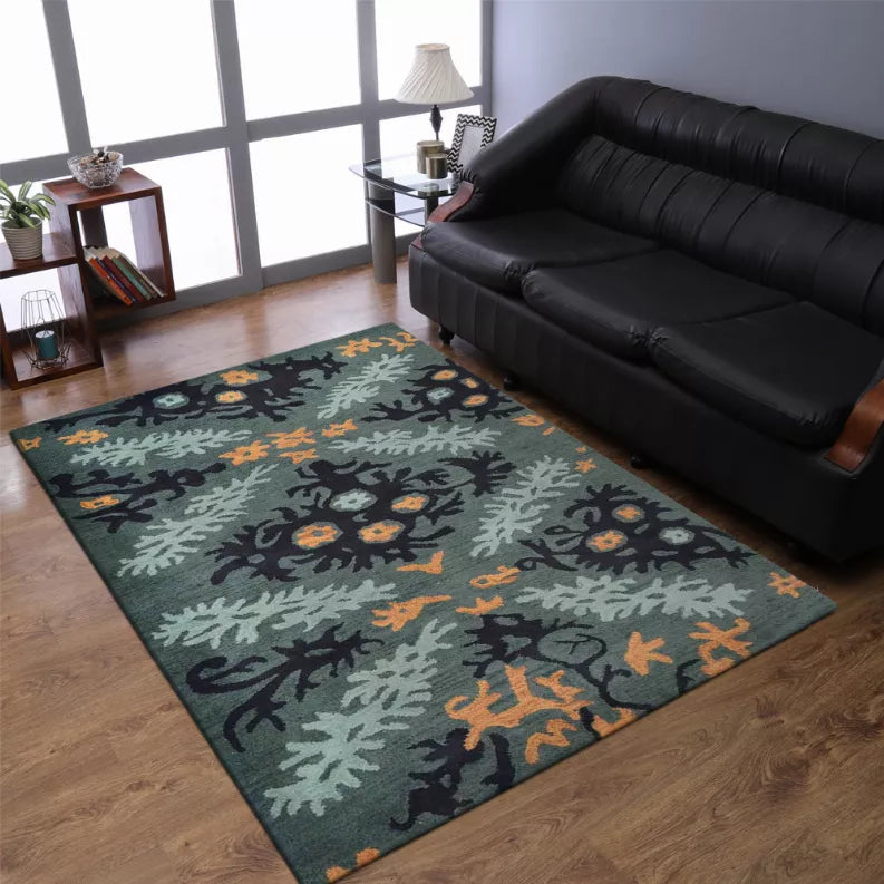 Hand-tufted wool area rug, dark floral foliage pattern in teal/gray with orange accents