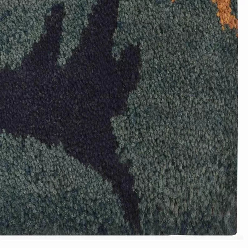 Hand-tufted wool area rug pile texture close-up with dense tufting, teal-gray and dark purple