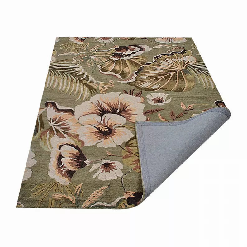 Floral wool area rug corner with gray backing showing on the underside