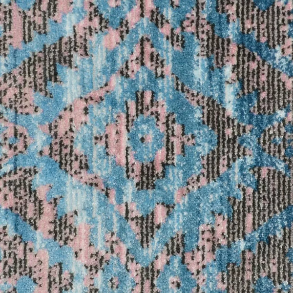 Machine-woven area rug with blue, pink, and dark gray diamond pattern.