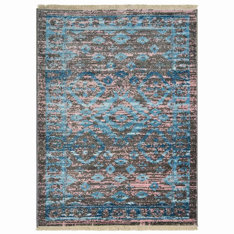 Oriental-style area rug with blue, gray, and pink geometric pattern and short fringe.