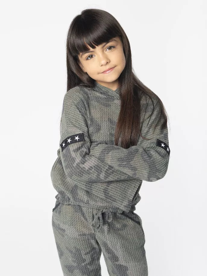 Kids camouflage hoodie close-up with crossed arms and star sleeve patch