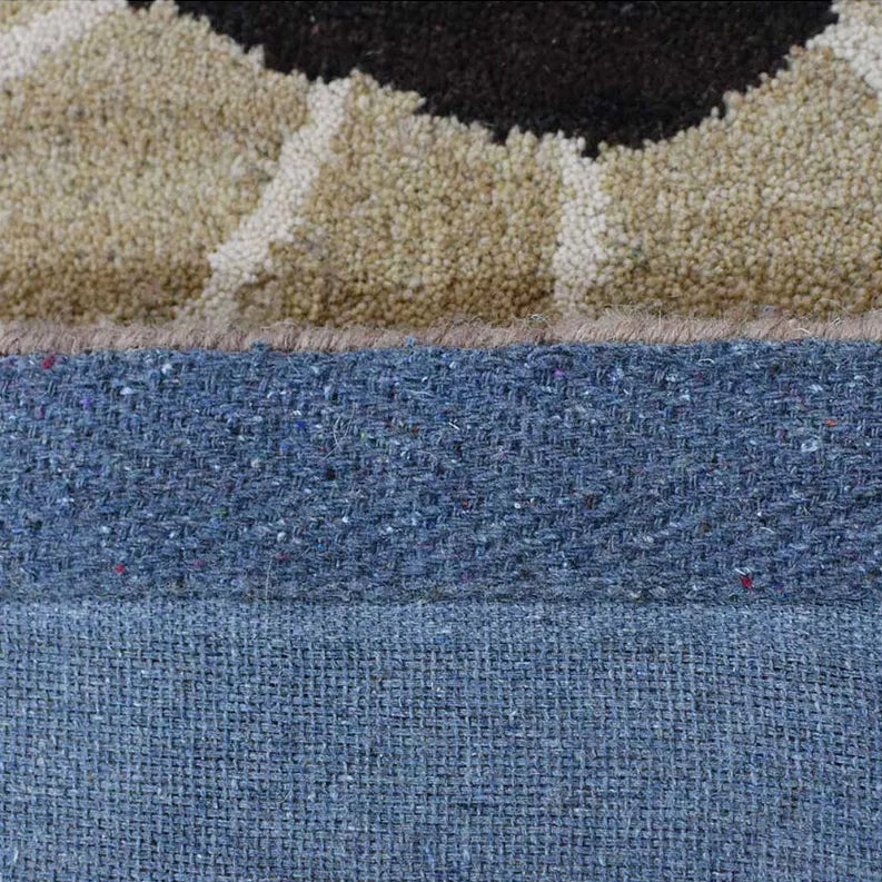 Blue textured loop pile area rug with beige forms and dark edge border