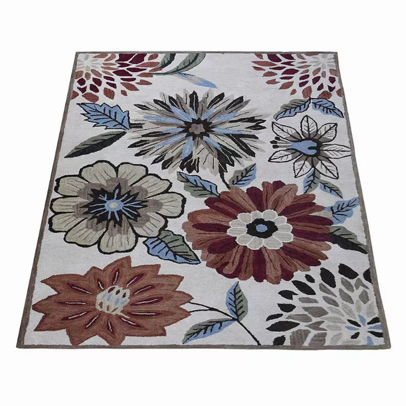 Floral area rug with large multicolor blossoms, leaves, and dark trim edge