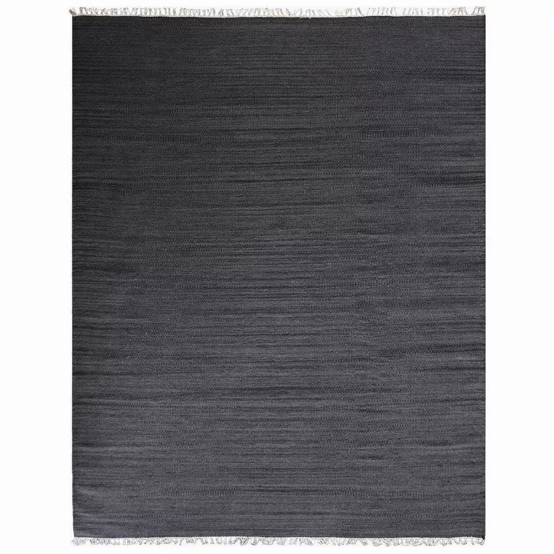 Dark gray wool kilim area rug with subtle horizontal stripes and fringe edging