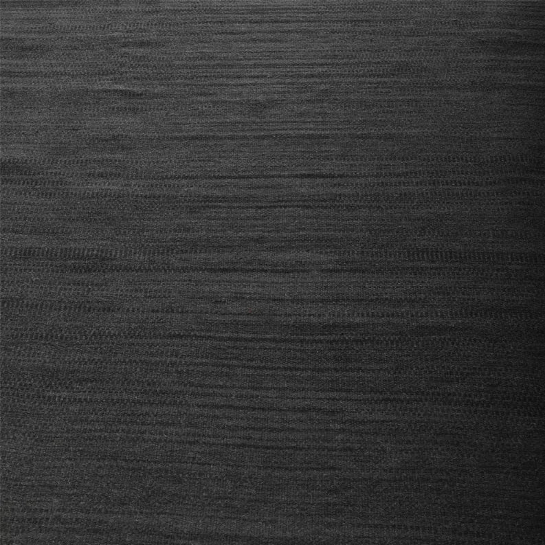 Dark gray wool rug surface with flat woven kilim texture in subtle stripes